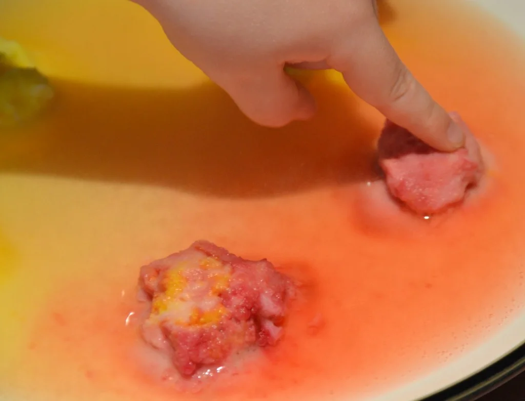 Vinegar being poured over rocks made from baking soda
