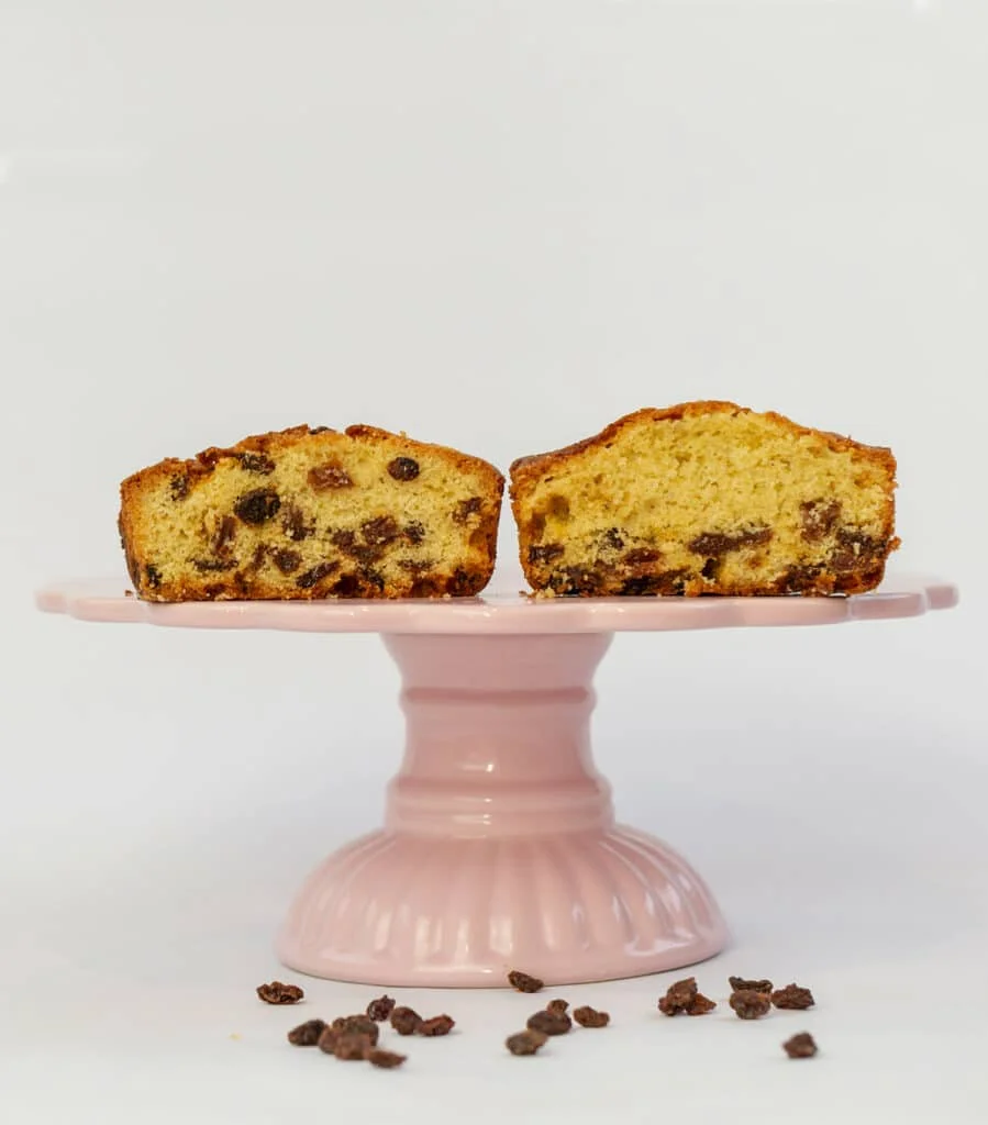 Two slices of fruitcake showing raisins
