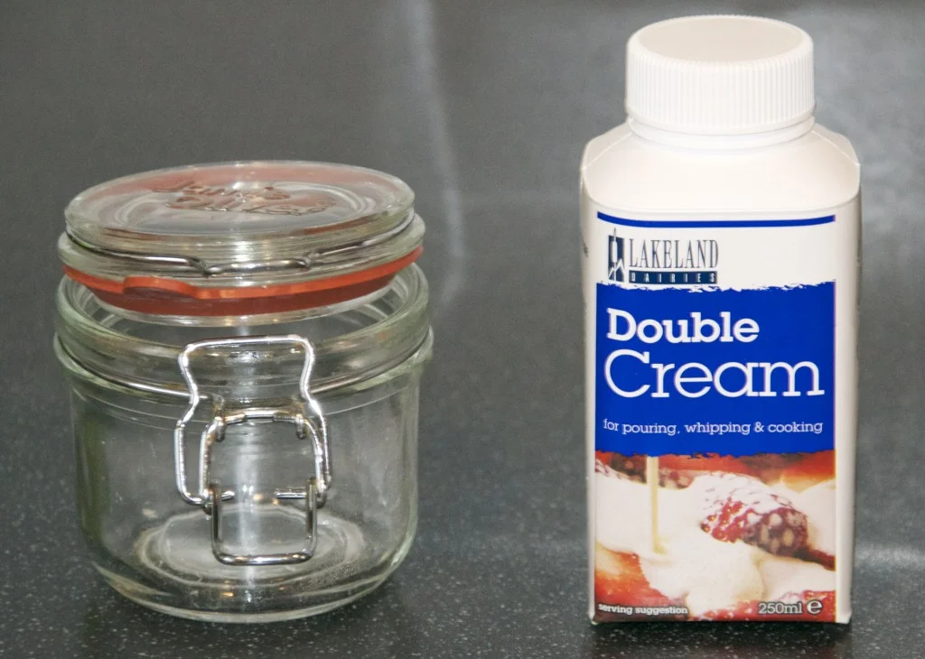 Making butter Glass jar and a carton of double cream for a making butter science activity